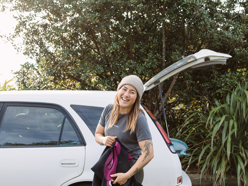 A young woman with her first car.