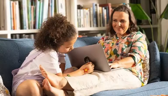 A mother and daughter enjoying time together on the couch
