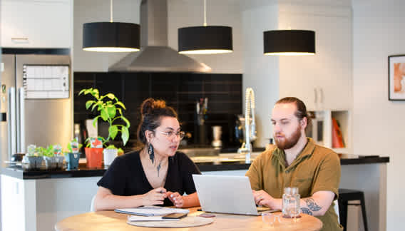couple at laptop in dining room