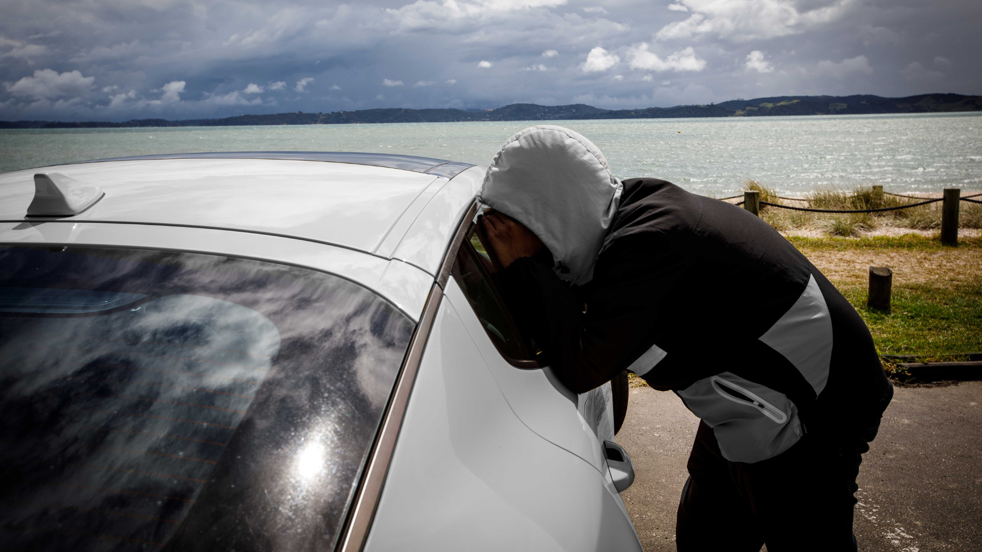 Person looking into car