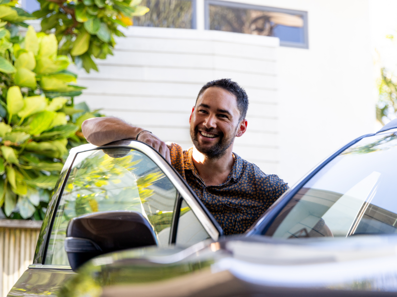 Young man getting into his car.