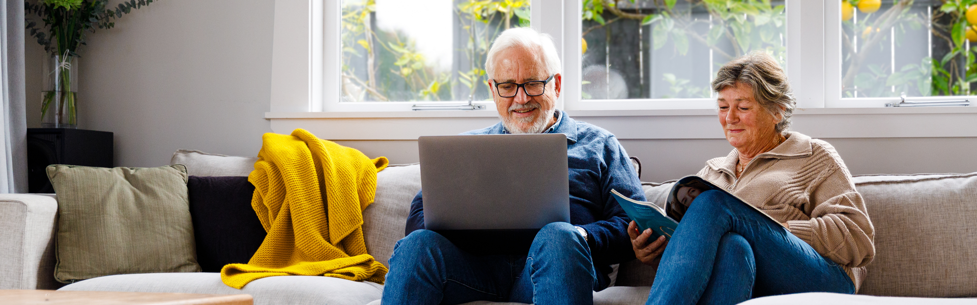 Couple on couch with laptop.
