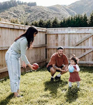 Young family playing in yard