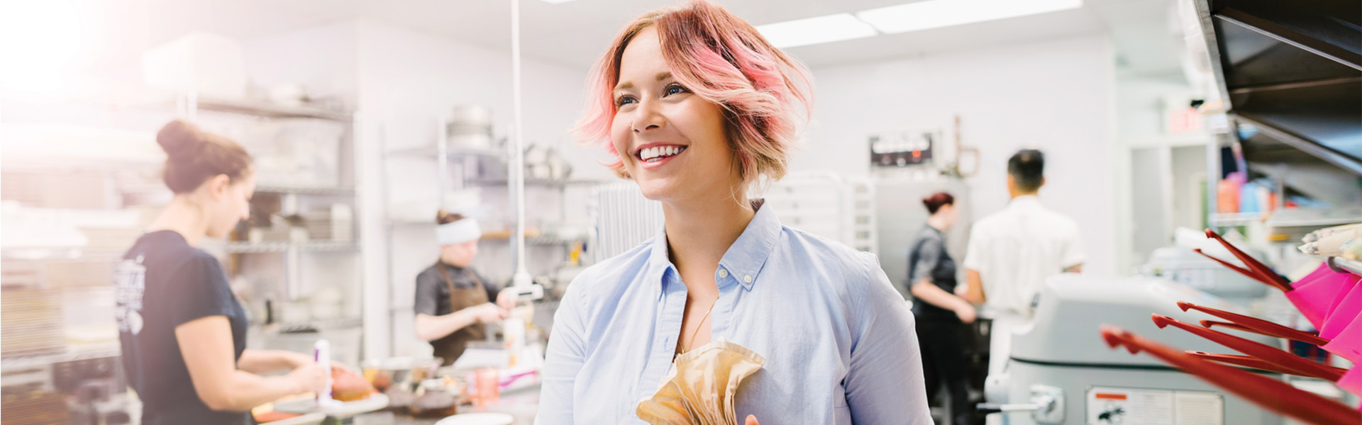 pink haired baker icing cookies