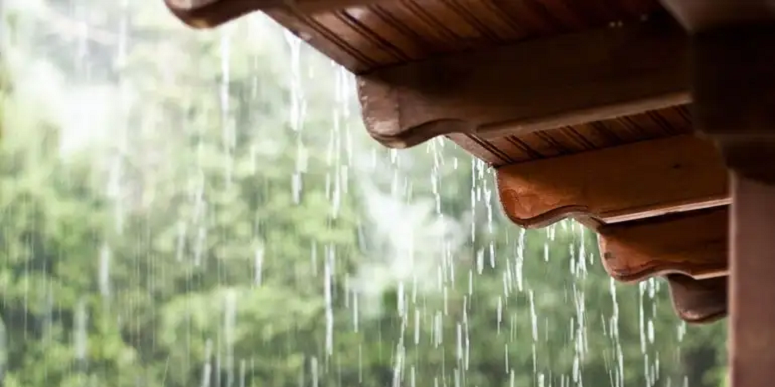roof of house with rain coming down