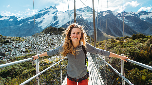 Woman holds onto bridge