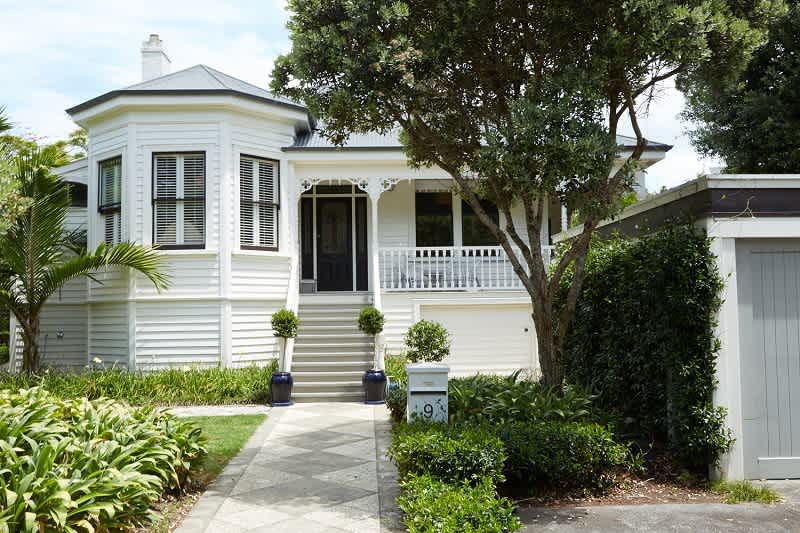 White Victorian house with garden and garage.