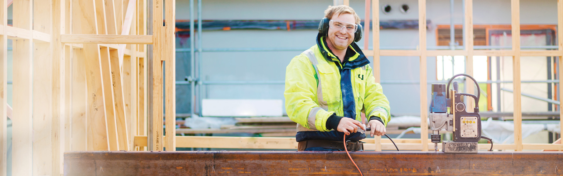a happy tradie plugging in equipment on a building site