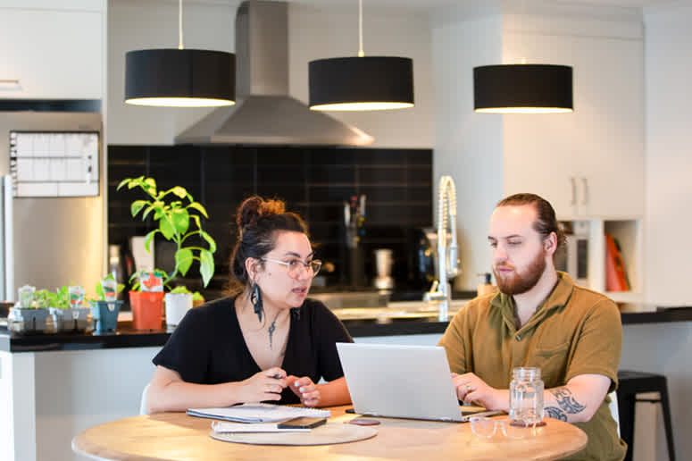 couple at laptop in dining room