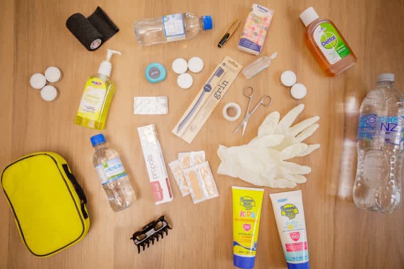 Easy home emergency kit with plasters, disinfectant, water and other useful items.