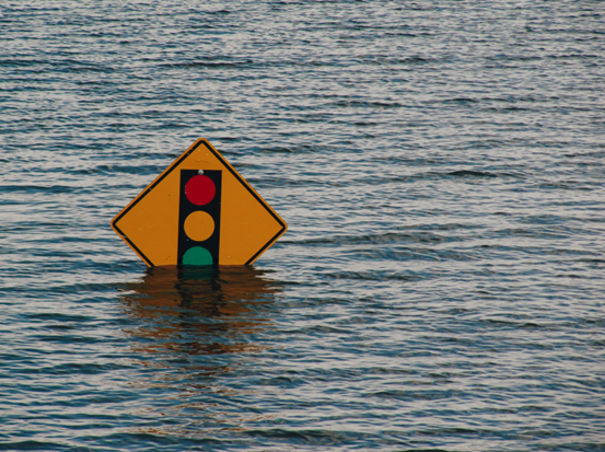 Water covering a street sign after a tsunami.